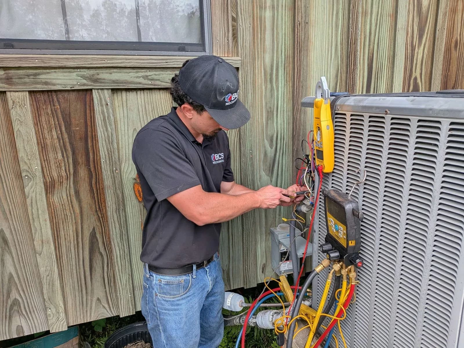 BCS Mechanical technician servicing an outdoor condenser